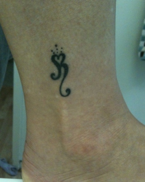 Interesting painted small ankle tattoo design for woman