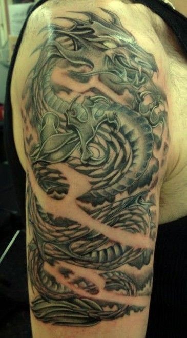 Iron dragon tattoo on half sleeve