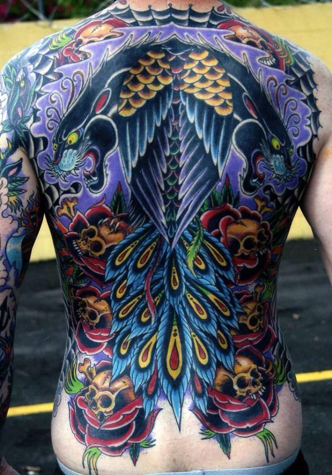 japanese style colored whole back tattoo of black panther with skulls and feather
