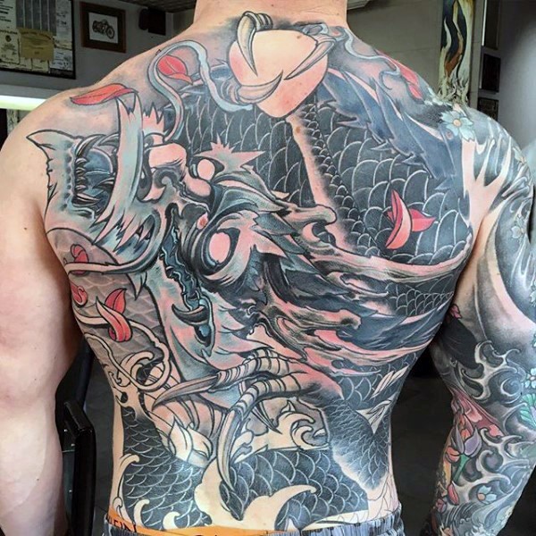 Japanese traditional style colored whole back and sleeve tattoo of fantasy dragon with magical orb