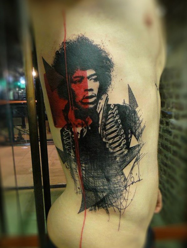 Jimmy Hendrix portrait like colored detailed tattoo on thigh