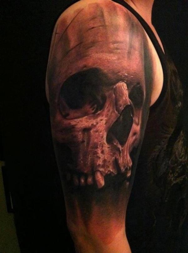 Large black and gray style old human skull tattoo on shoulder