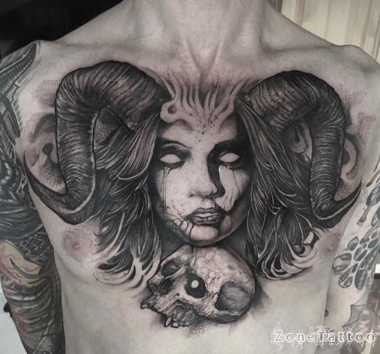 Large black and white chest tattoo of demonic woman with skull