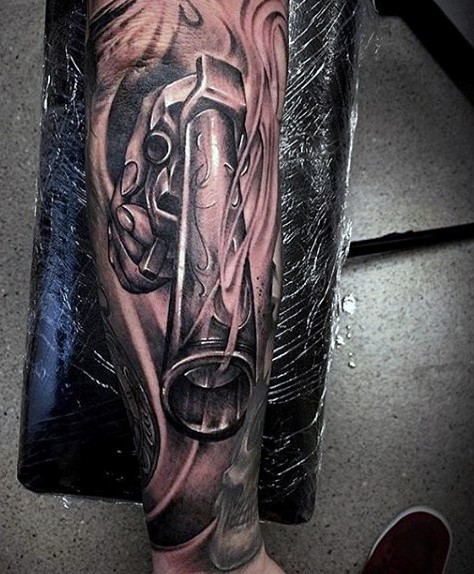 Large black ink 3D style forearm tattoo of old revolver