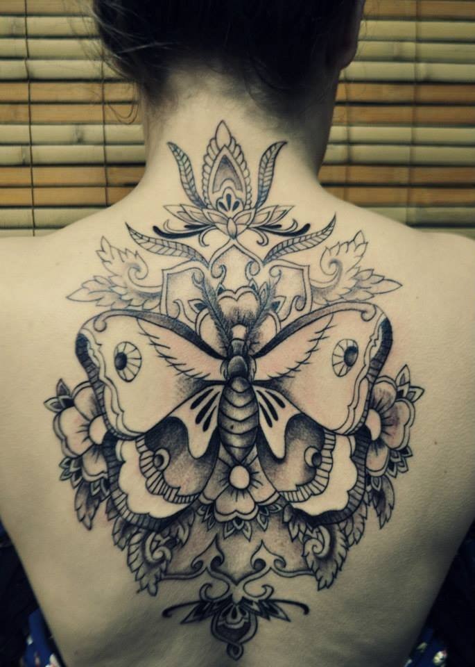 large black ink back tattoo of cool butterfly with flowers