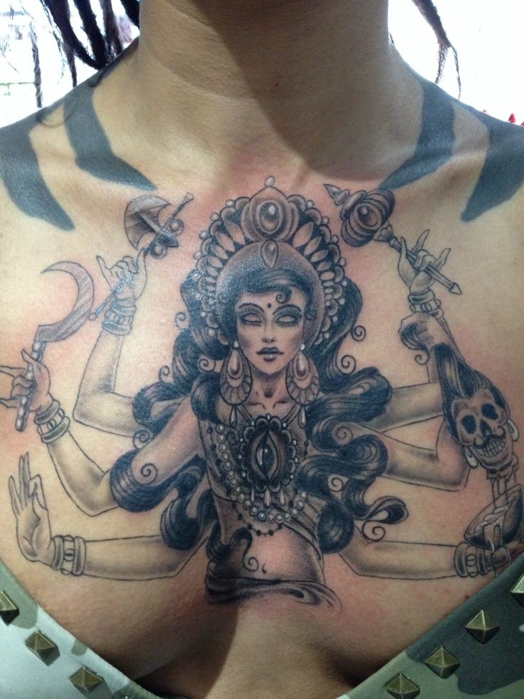 Large black ink chest tattoo of Hinduism Goddess with eye