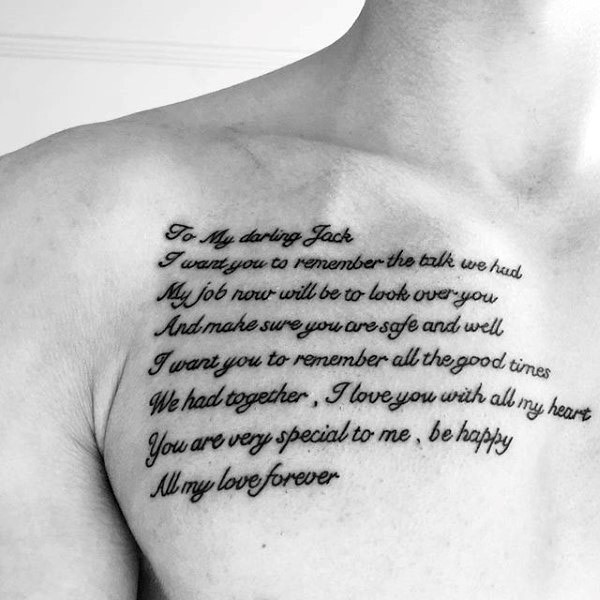 Large black ink lettering tattoo on chest