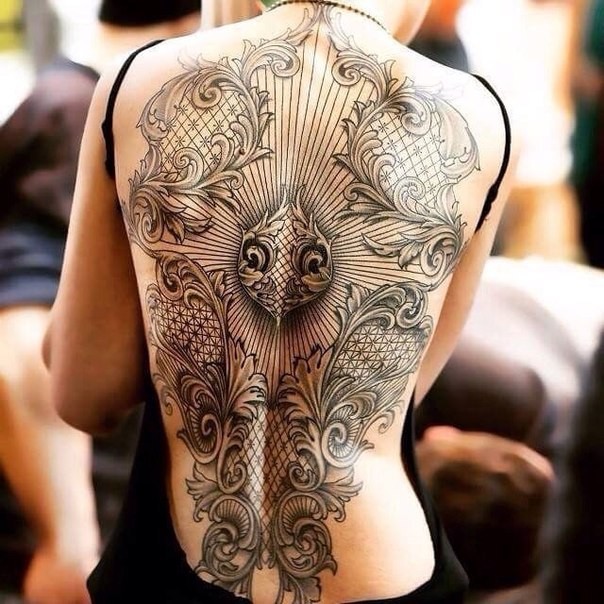 Large black ink ornamental style whole back tattoo