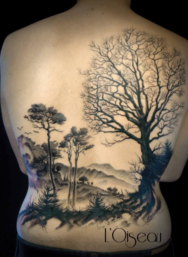 Large black ink whole back tattoo of big forest