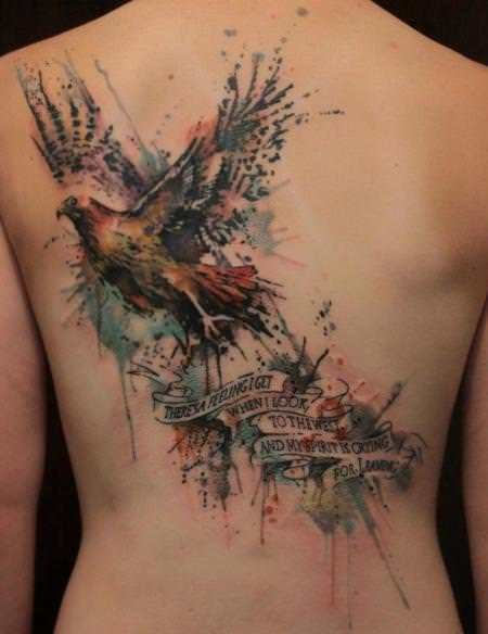 Large colored bird tattoo on the back