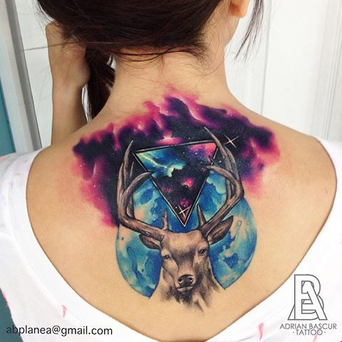 Large colored illustrative style upper back tattoo of deer with space and planet