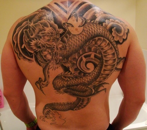 Large colorful dragon and crystal ball tattoo on back