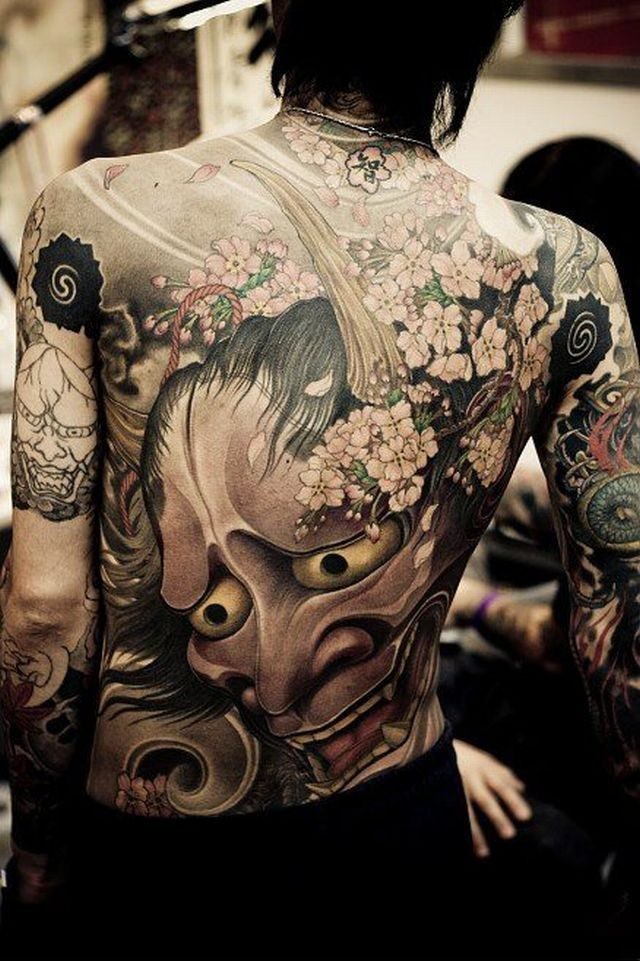 Large demon mask tattoo on back in asian style