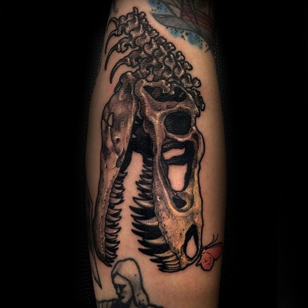Large engraving style forearm tattoo of dinosaur skeleton
