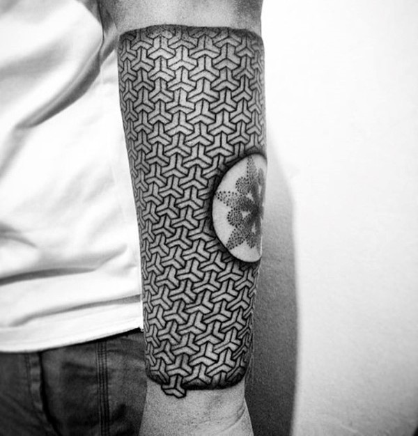 Large geometrical black ink arm tattoo of identical ornaments combined with circle with flower