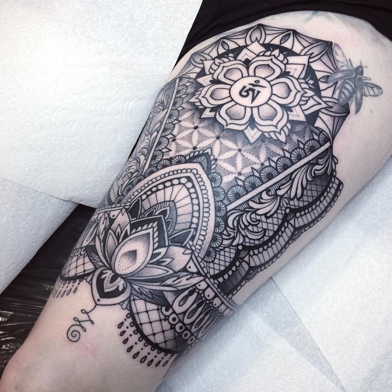 Large Hinduism themed thigh tattoo of big ornament with symbol