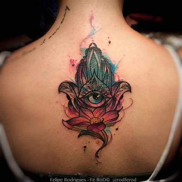 Large illustrative style colored back tattoo of Hamsa amulet and flower