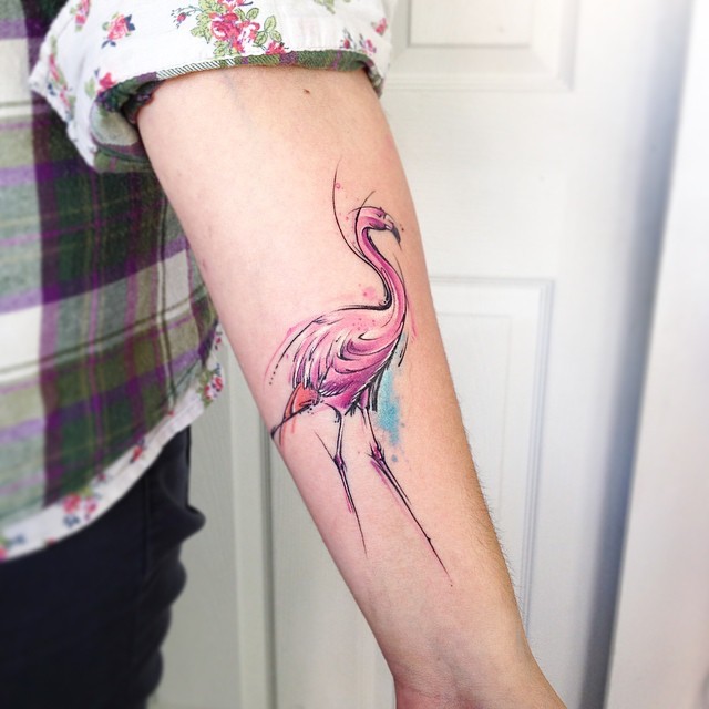 Large illustrative style colored forearm tattoo of flamingo