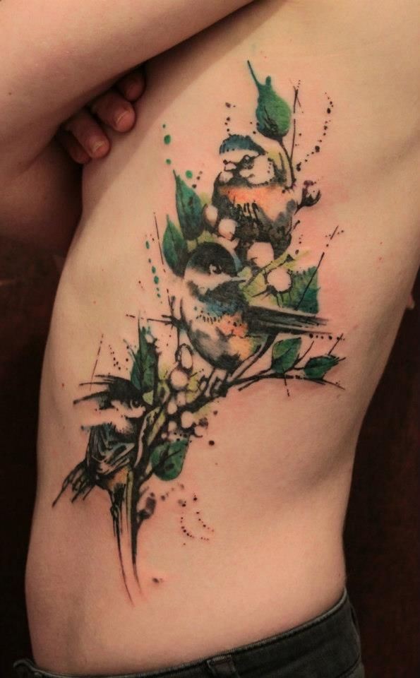 Large illustrative style watercolor side tattoo of birds on tree