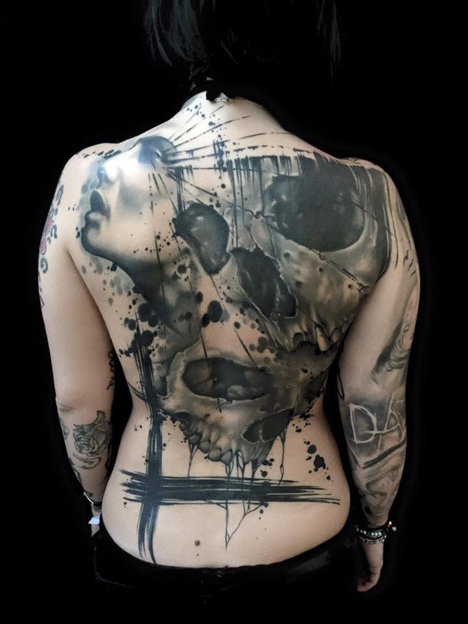 Large incredible looking human skull with woman face tattoo on whole back