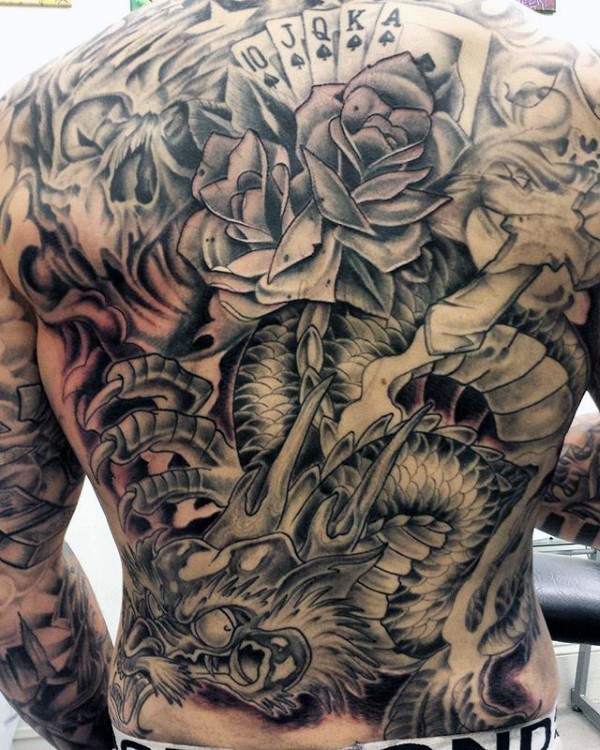 Large japanese style colored whole back tattoo of dragon with rose and playing cards