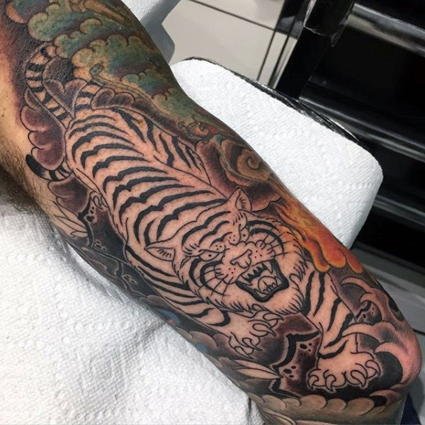 Large Japanese traditional colored half sleeve tattoo of tiger in jungle