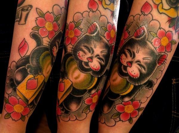Large multicolored arm tattoo of beautiful maneki neko japanese lucky cat with flowers and tablet