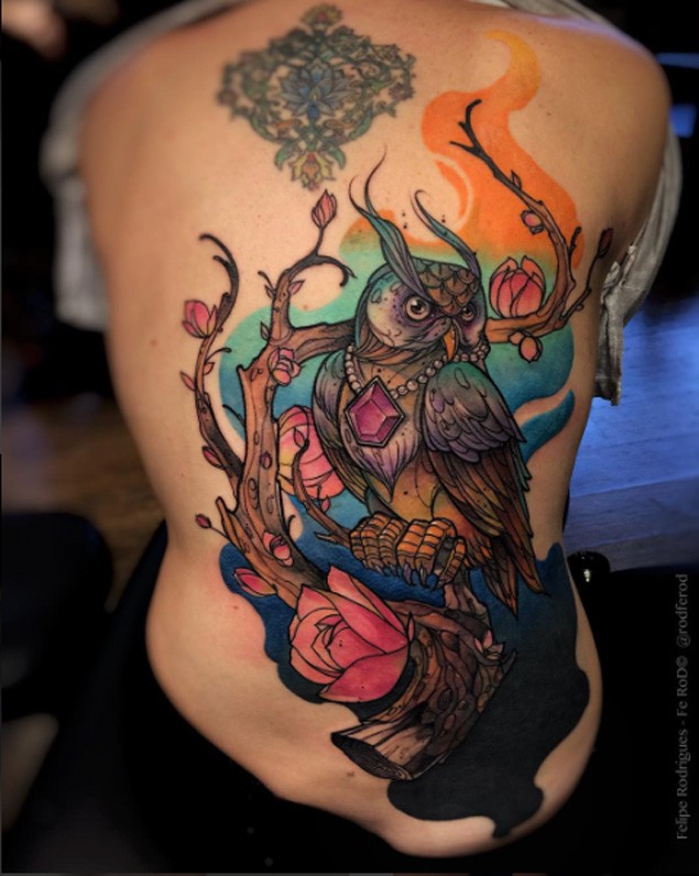 Large new school style colored whole back tattoo of fantasy owl with tree and flowers
