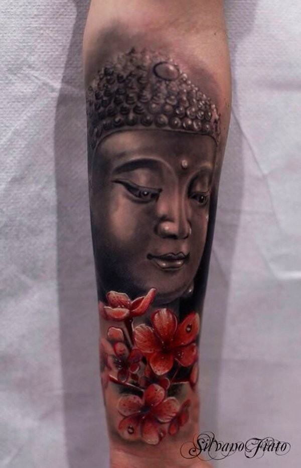 Large realism style colored forearm tattoo of Buddha statue and flowers