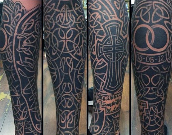 Large spectacular looking black ink leg tattoo of lettering and cross