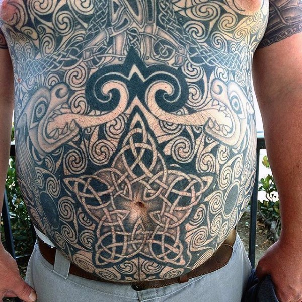 Large very detailed chest and belly tattoo of various knots and ornaments