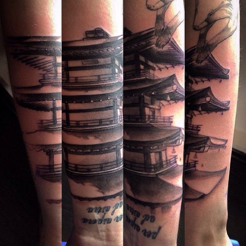 Life like colored big old Asian house tattoo on forearm combined with lettering