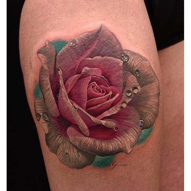 Lifelike beautiful looking thigh tattoo of rose with water bulbs