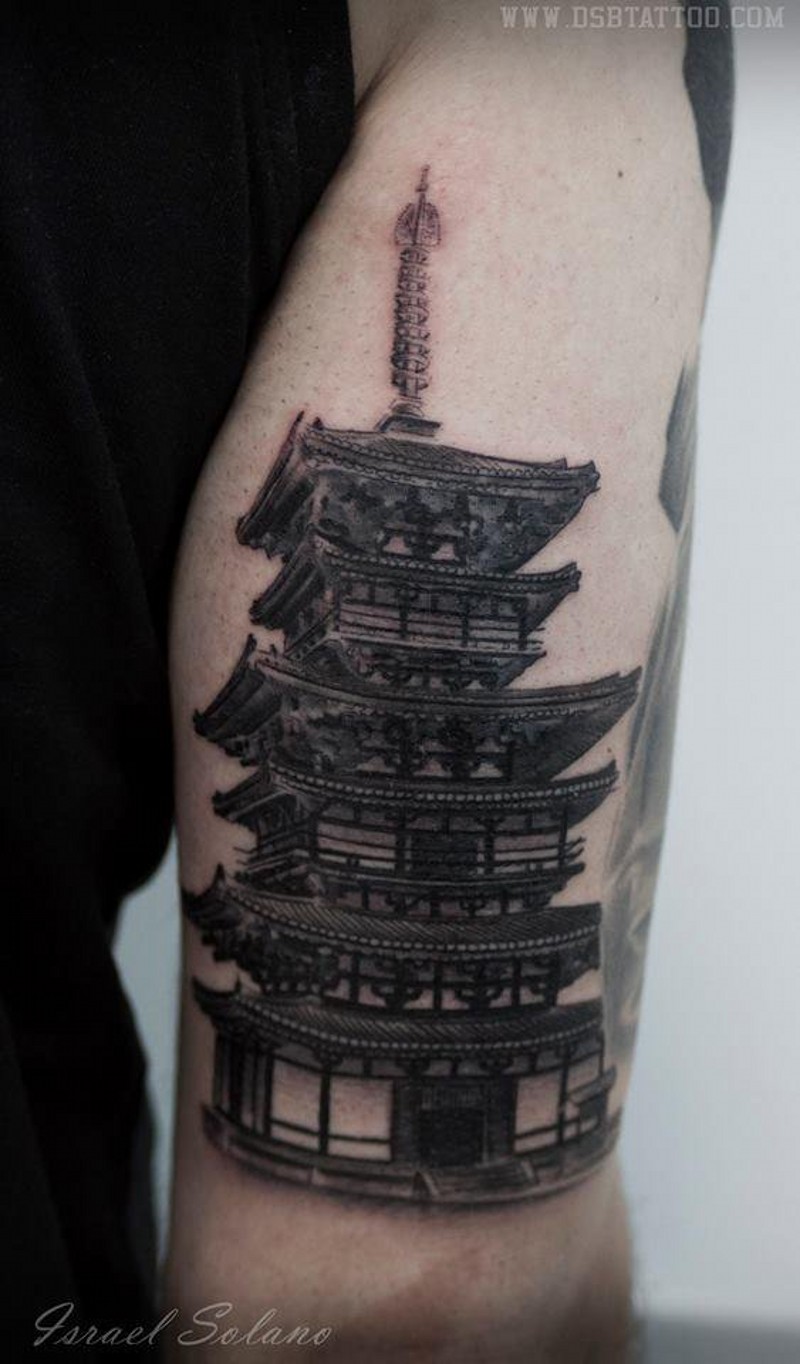 Lifelike black and wite detailed Asian temple tattoo on upper arm