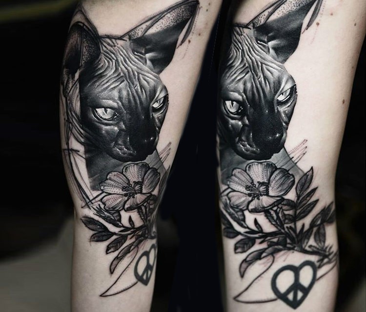 Lifelike black in shoulder tattoo of Sphinx cat with flower