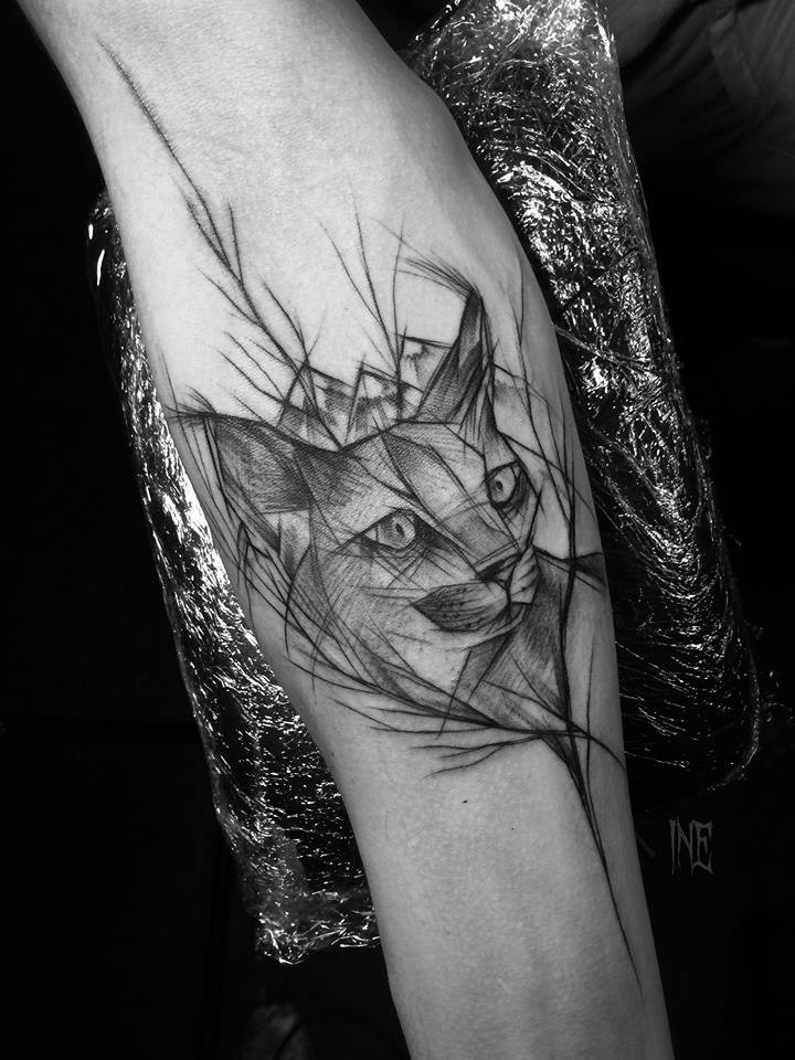 Lifelike black ink forearm tattoo by Inez Janiak of wild cat