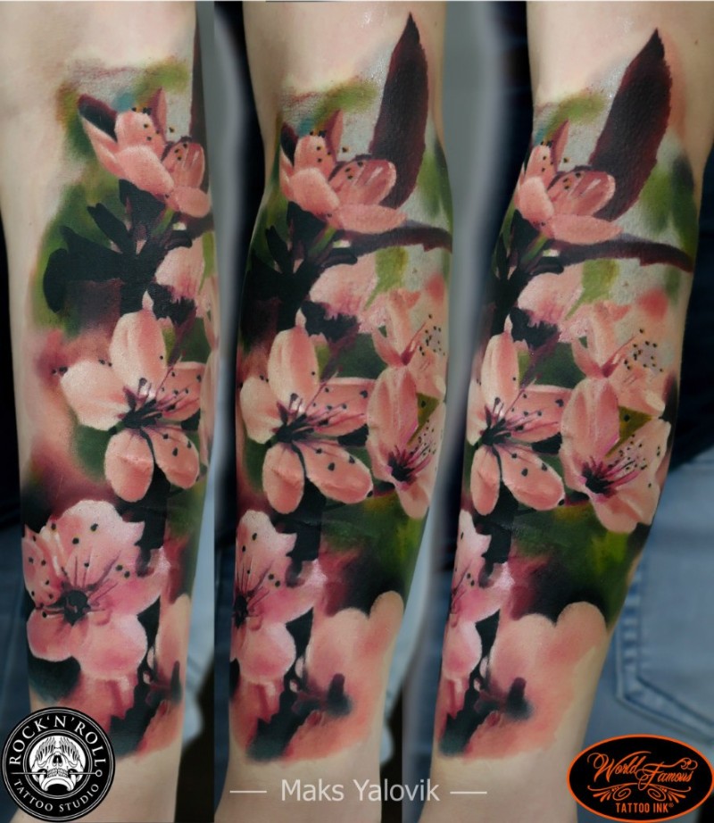 Lifelike colored arm tattoo of big pink flowers