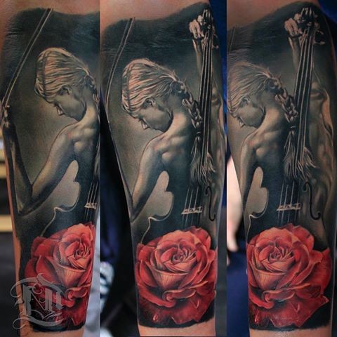 Lifelike colored forearm tattoo of woman with violin with rose
