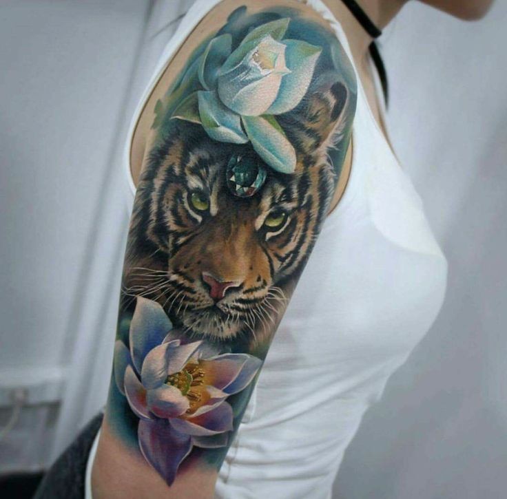 Lifelike colored shoulder tattoo of little liger with flowers