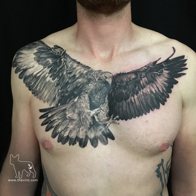 Lifelike very detailed colored chest tattoo of flying eagle