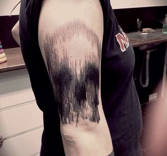 Linework black ink shoulder tattoo of human skull