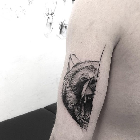 Linework style black ink upper arm tattoo of roaring bear head