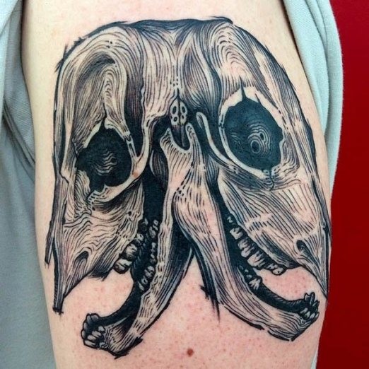 Linework style black ink upper arm tattoo of animal skull