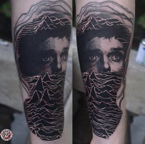 Linework style colored forearm tattoo of mountains and face