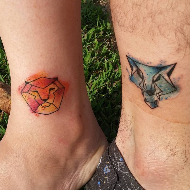 Lion and wolf&quots heads couple or friendship geometrical tattoo on ankle in watercolor style