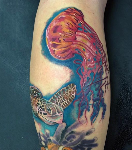 Little accurate painted and colored jellyfish with turtle tattoo on arm