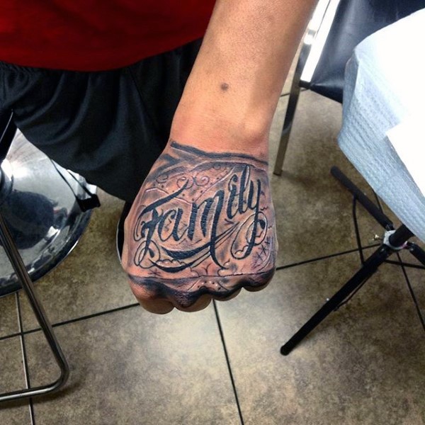 Little black and white beautiful lettering tattoo on fist