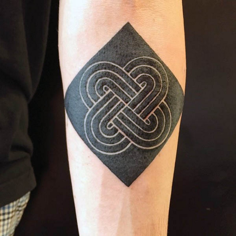 Little black and white Celtic symbol tattoo on arm