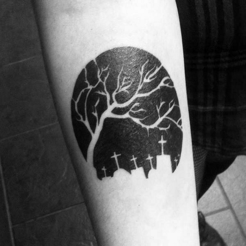 Little black and white dark tree on cemetery arm tattoo