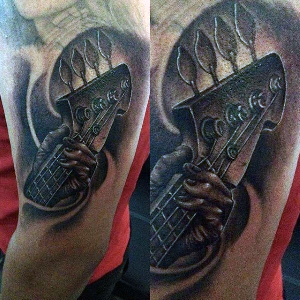 Little black and white detailed bass guitar tattoo on arm